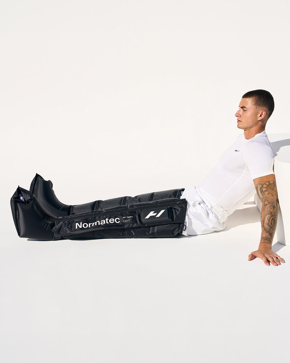 Person wearing Normatec recovery compression devices